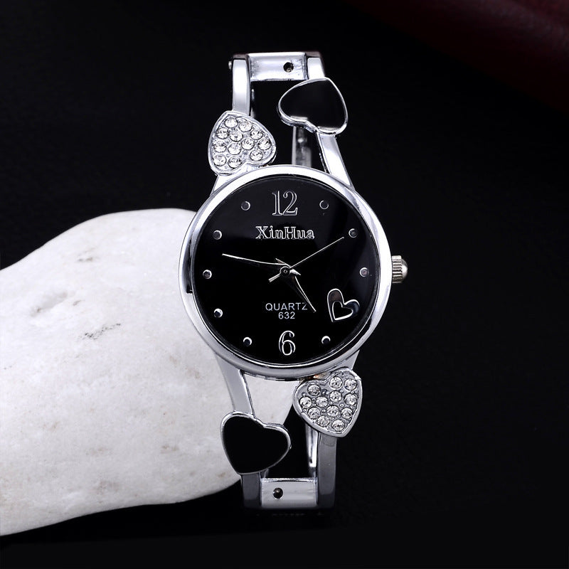 Britique women's diamond-set quartz watch with stainless steel pin buckle, black dial and crystal heart accents.